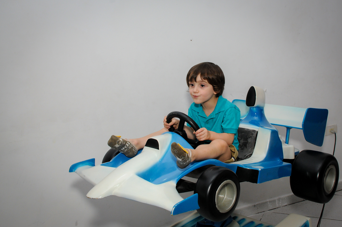 brincando no carrinho de corrida no Buffet Planeta 2, Butantã, SP, festa infantil fotografia infantil, aniversário de Fabrício 4 anos tema da mesa dinossauros