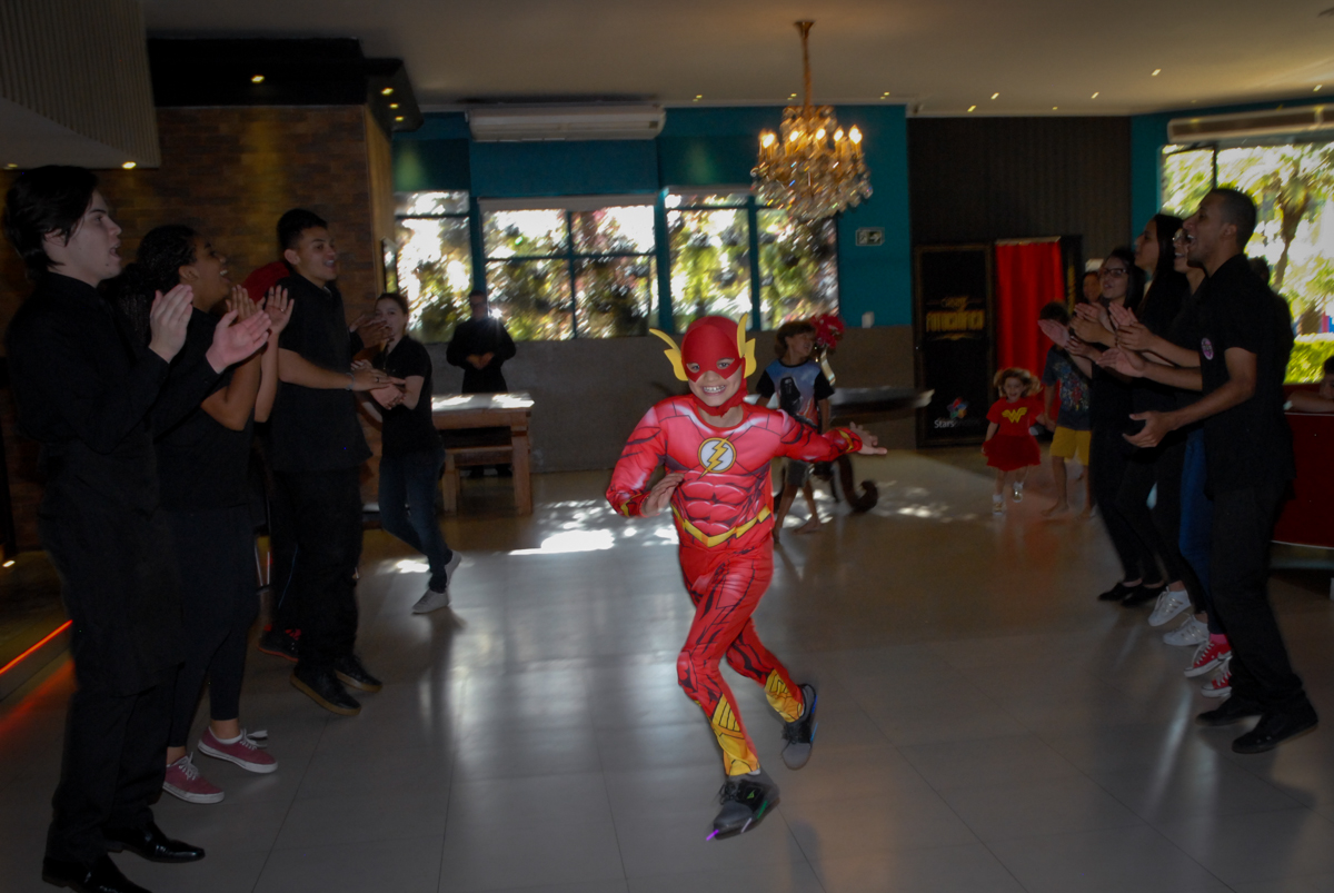 correndo para a mesa do parabéns no Buffet Planeta Prime, Alphaville, São Paulo, aniversário de Rafael 10 anos, tema da festa The Flash