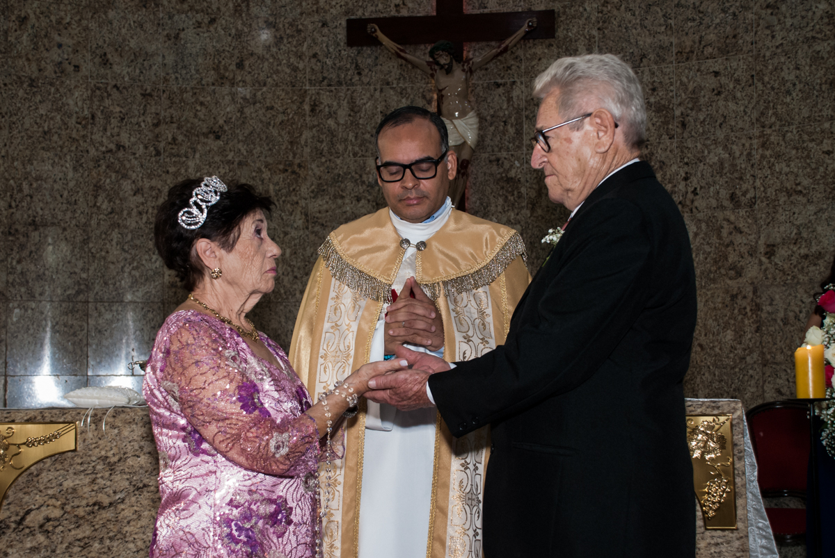O padre abençoa as alianças na Bodas de Ouro Maria Luiza e José Rodrigues, igreja Santa Ângela e São Serapio, Ipiranga