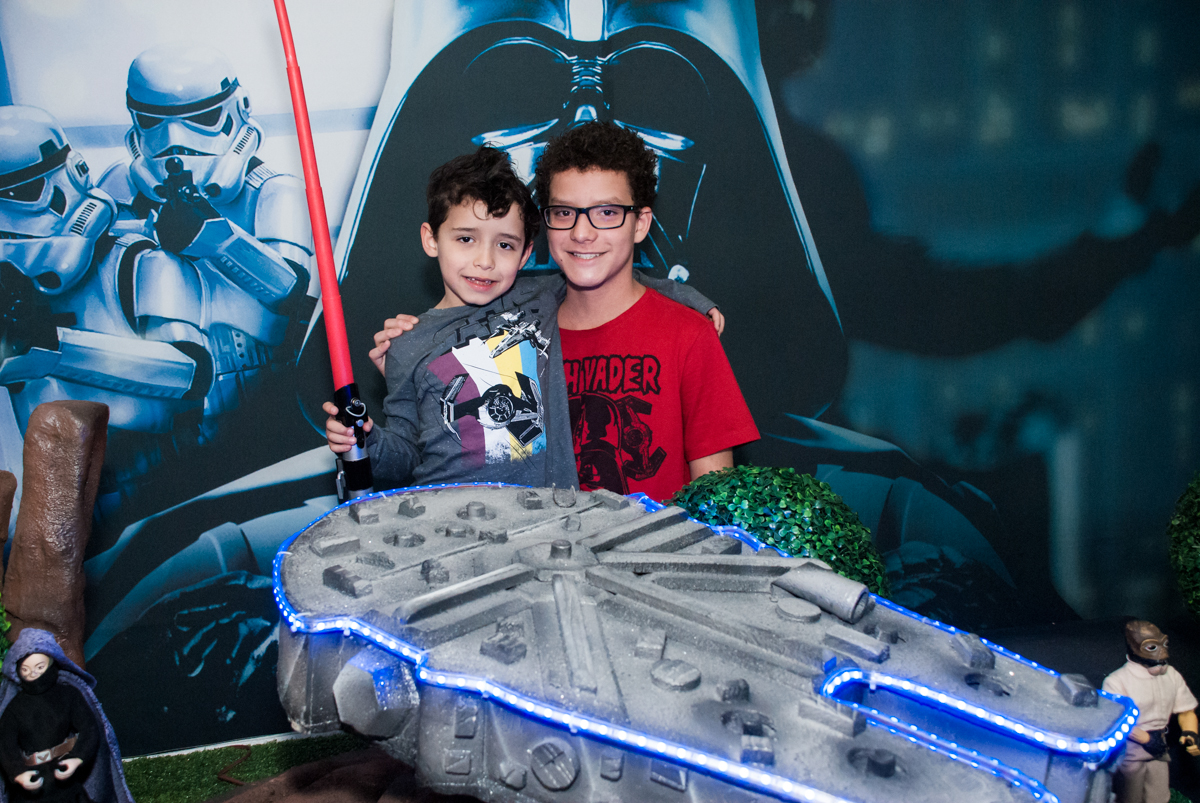 abraço dos irmãos em frente a mesa temática