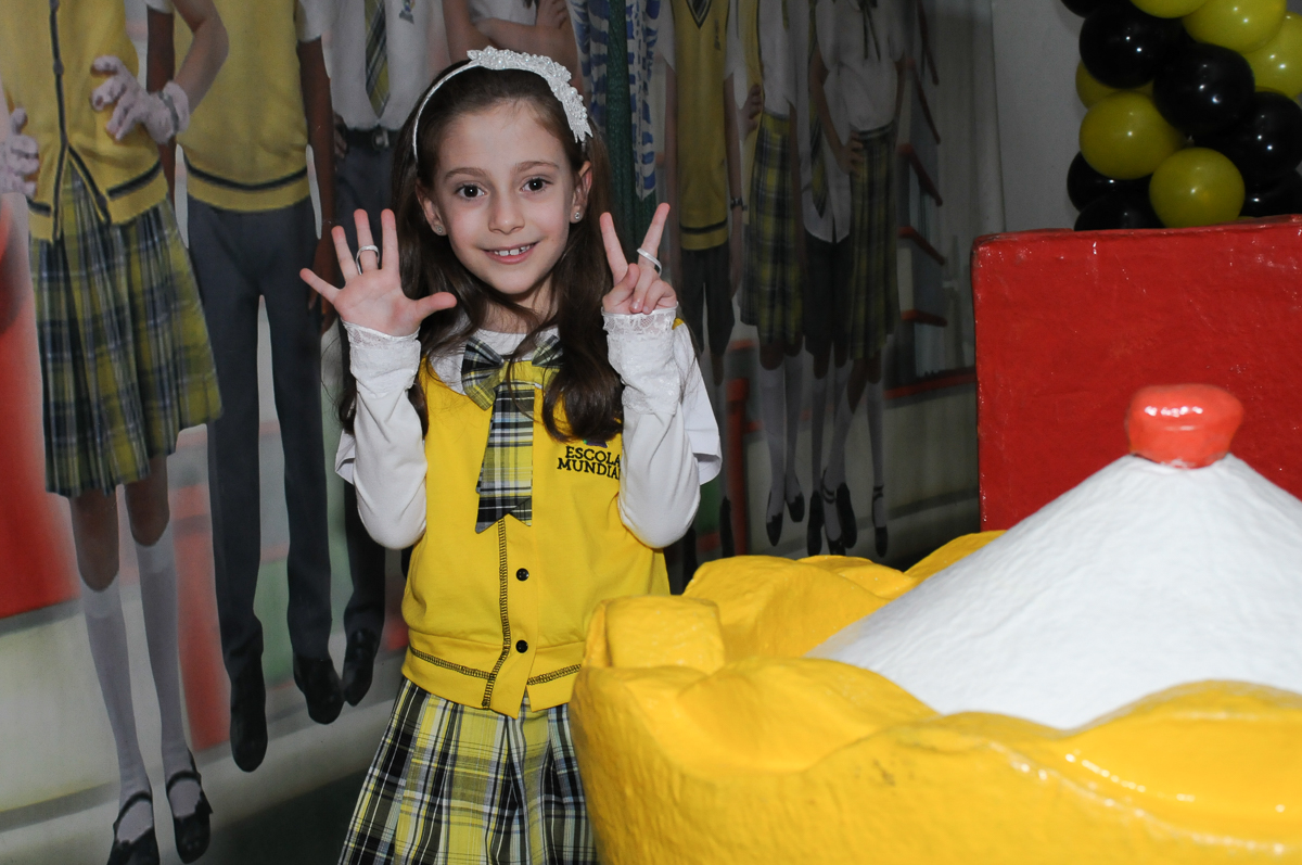 Lara em frente a mesa decorada carrossel no Buffet Zezé e Lelé