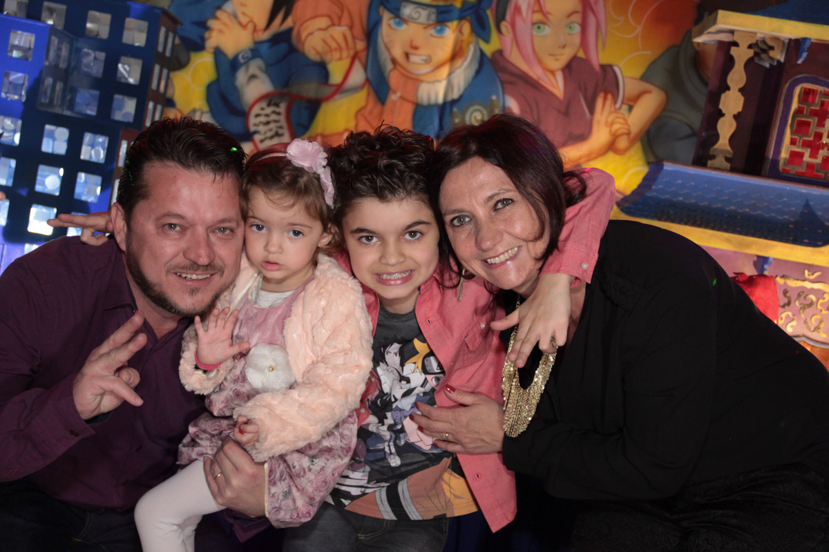 close da família em frente a mesa decorada naruto no Buffet Planeta Prime, Alphaville