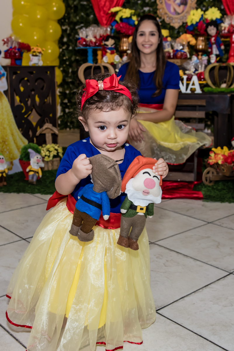sapeca e engraçadinha brinca e sai andando com os bonecos da mesa na mão