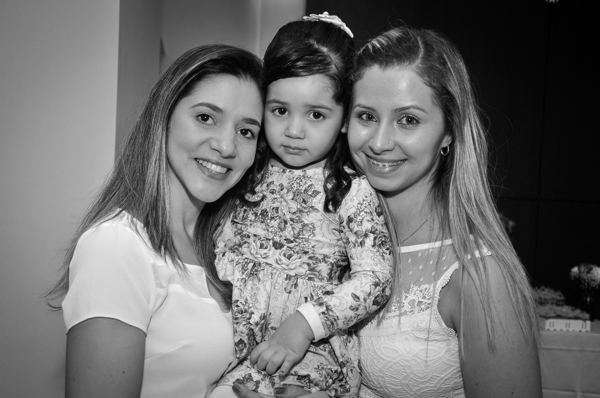 A mãe do Matheus faz fotos com os convidados na festa de batizado festa no condomínio