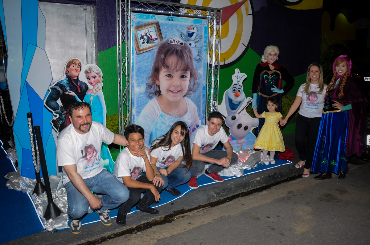 família sendo fotografada na fachada do buffet no Buffet Fábrica da Alegria, Morumbi