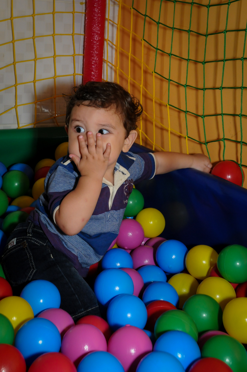 o aniversariante joga beijinho enquanto brinca na piscina de bolinha na Festa Infantil, no condominio Osaco, SP, tema Galinha Pintadinha, Pietro 1 aninho