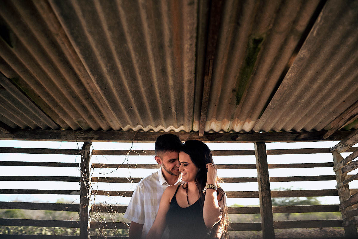 ensaio de Fernanda e Lucas em Catolé de Boa Vista no sitio do sua avó, linhas convergindo pra o casal, telhas de amianto, casal namorando