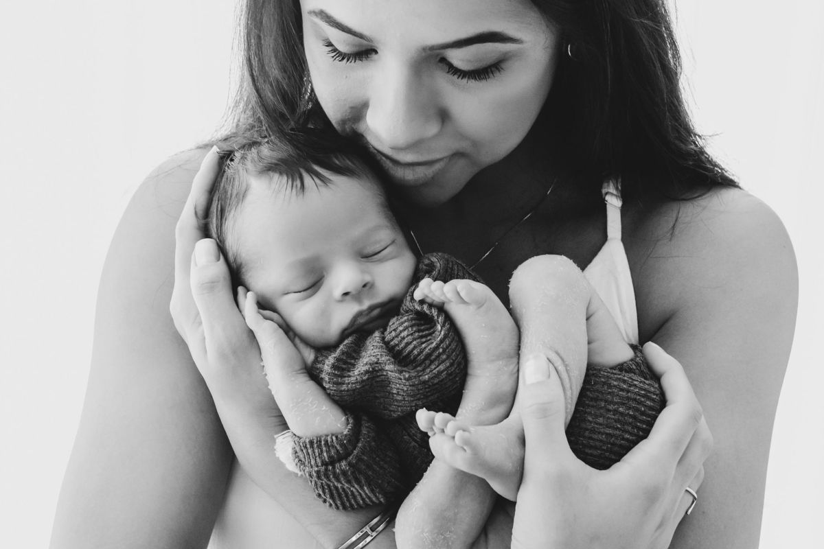 mãe abrançando seu bebe