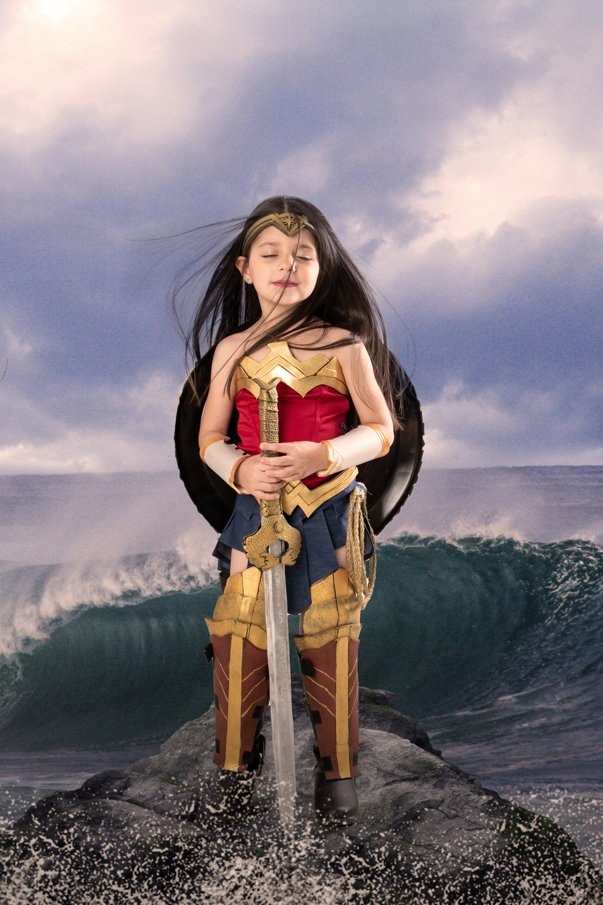 Ensaio fotográfico infantil tema Mulher Maravilha, com roupa do filme de 2017, escudo e espada realistas 