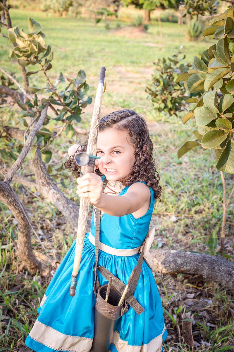 Ensaio infantil Valente Merida nossa filha Cecília arco e flecha diversão vestido azul