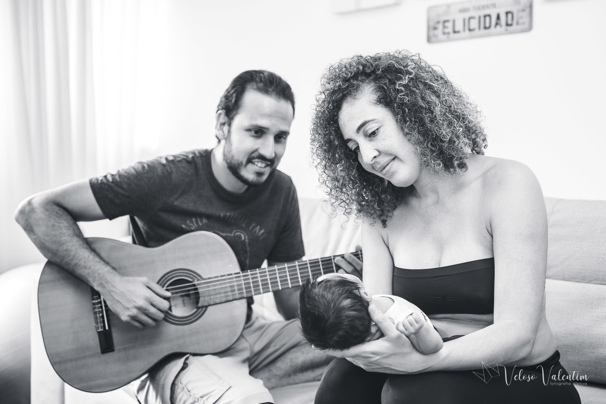 pai tocando violão para o filho bebê