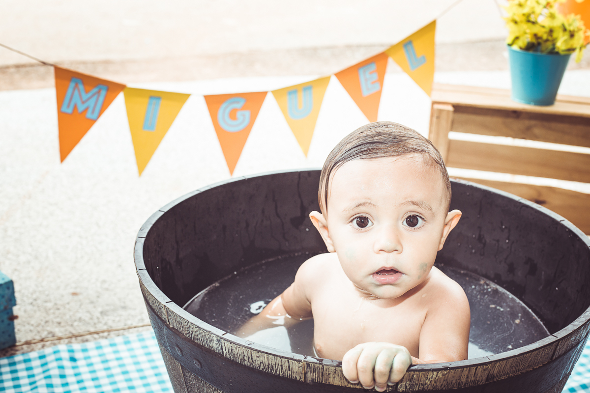 ensaio smash the cake tema foguete primeiro aninho parque da cidade família laranja e azul banho menino  Brasília DF veloso valentim book família fotografia bebê no banho