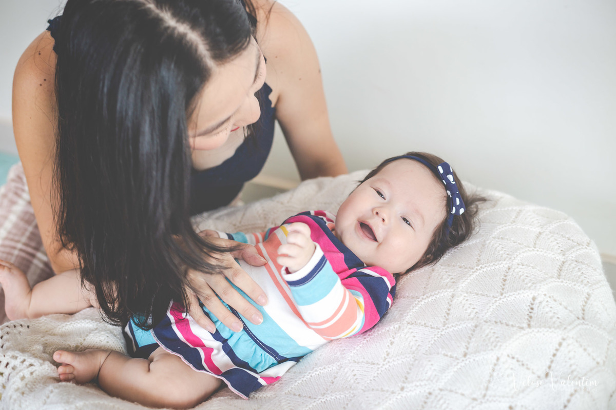 ensaio acompanhamento do primeiro ano do bebê Laura 3 meses em casa com a família ensaio lifestyle cotidiano Brasília DF Veloso Valentim fotografia afetiva família oriental mãe brinca com a bebê deitada