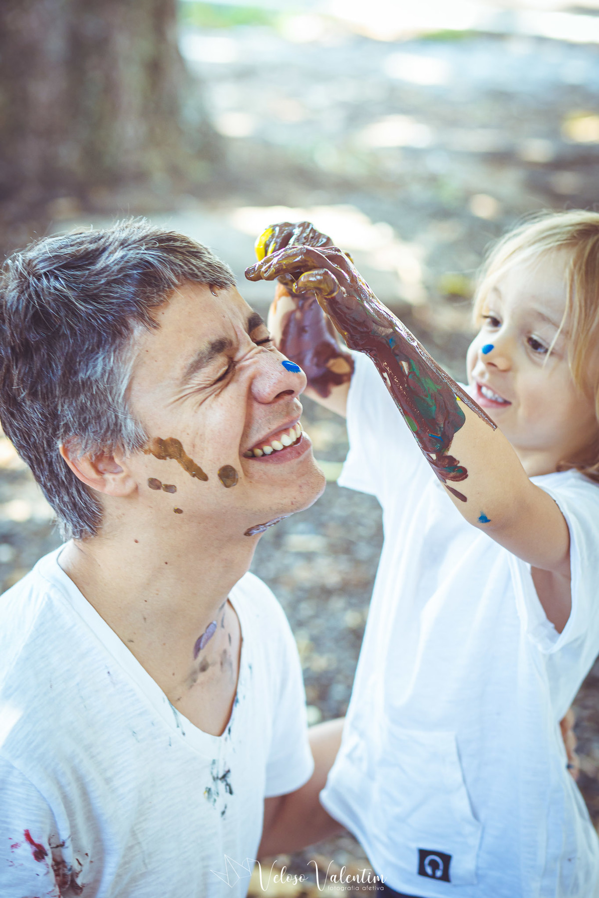 filho pintando o rosto do pai