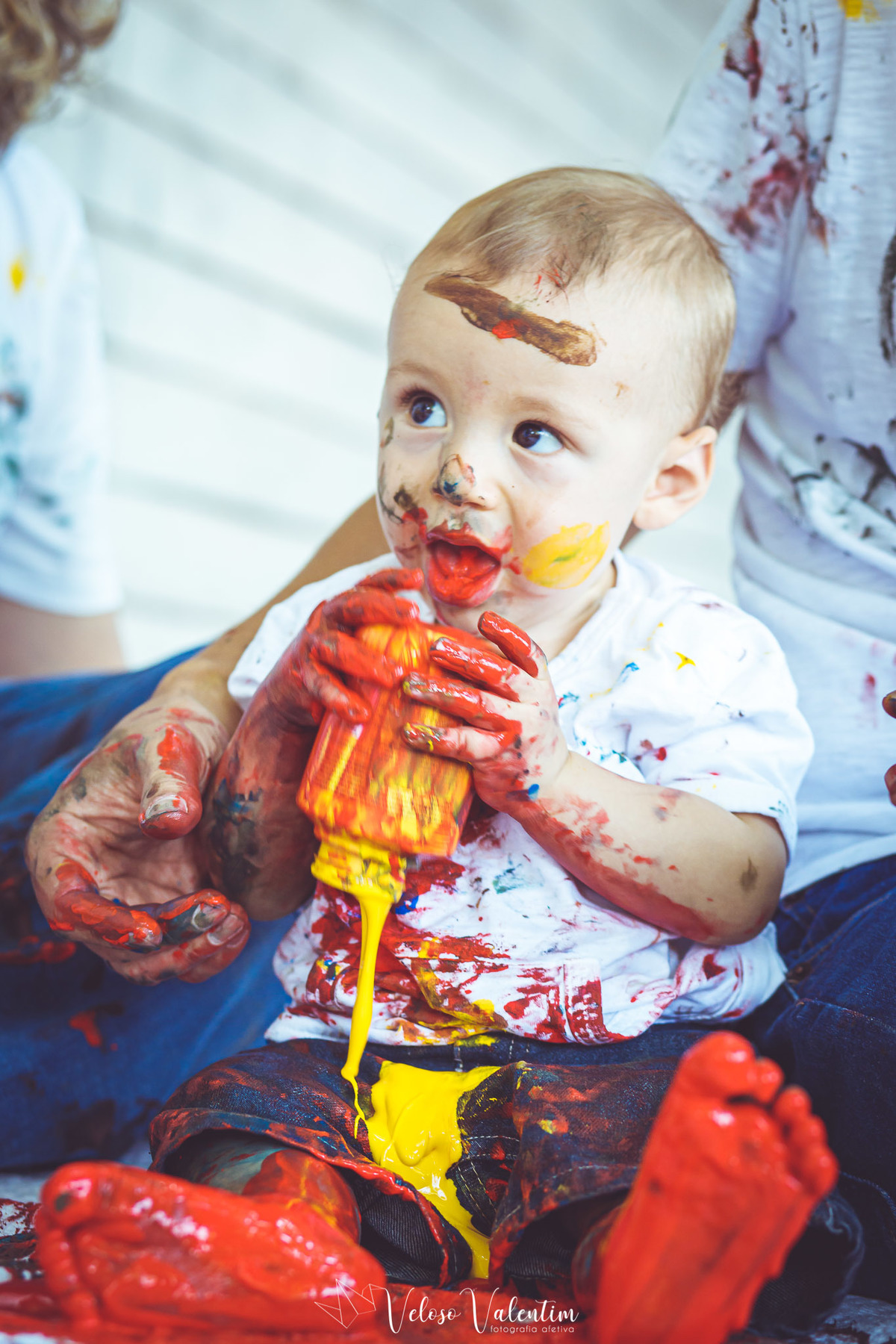 menino derramando pote de tinta