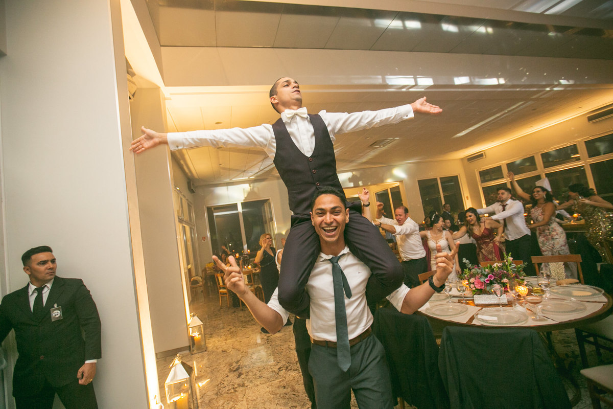 noivo montado no seu padrinho de casamento Crédito: Fotografo de casamento Rafael Ohana em Brasília