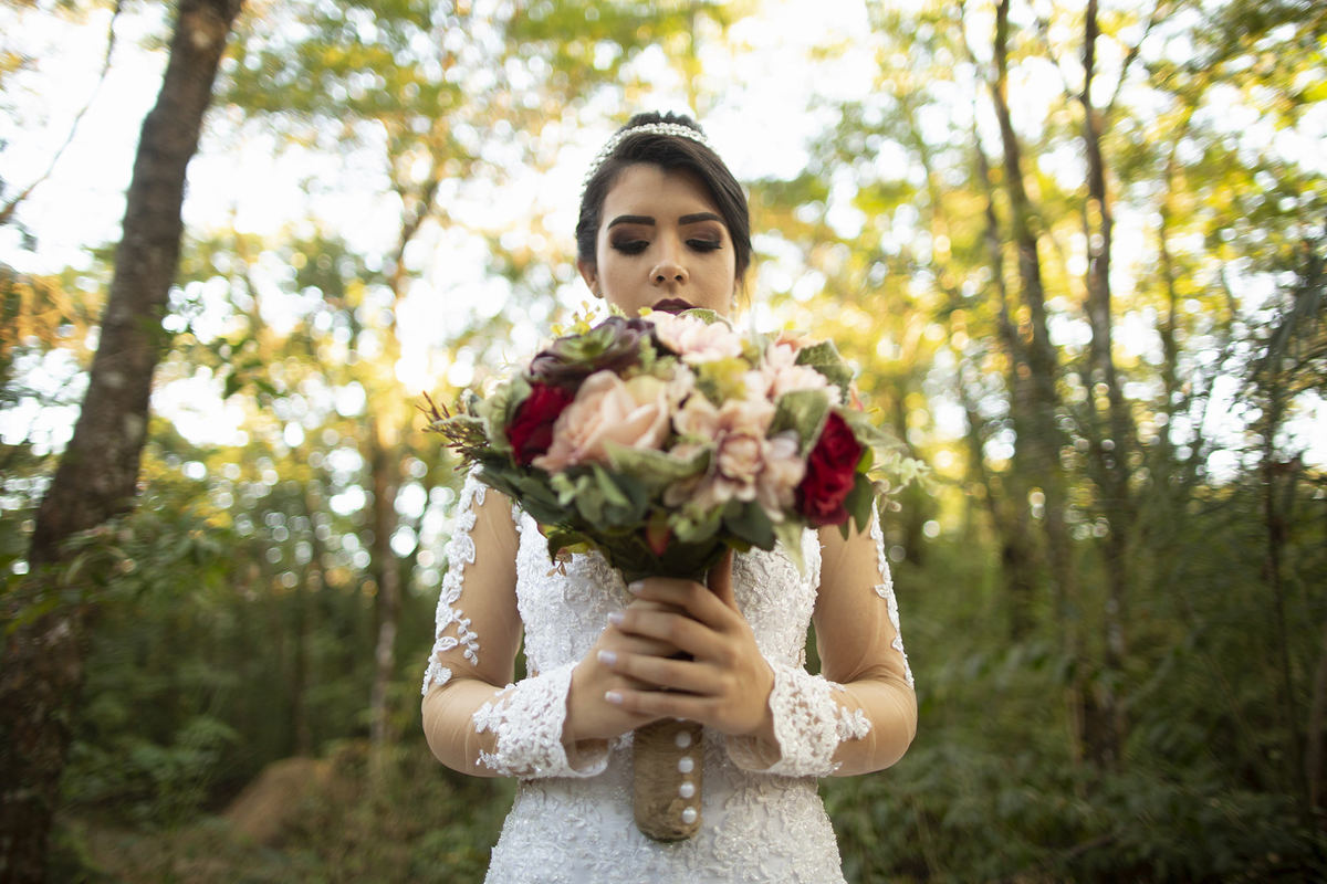 Noiva segurando buque na floresta. Foto feita pelo fotógrafo de casamento Rafael Ohana em Brasília