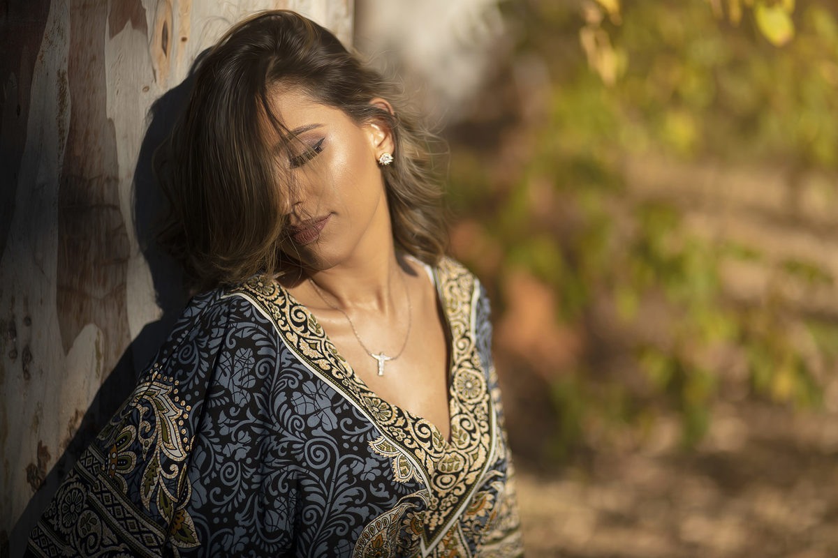 Mulher pegando sol encostada em arvore. Ensaio feminino feito pelo fotógrafo Rafael Ohana no Parque Olhos D´água em Brasília-DF 