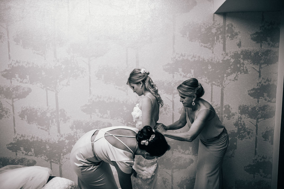 Mãe da noiva arrumando a filha para casar na praia. Casamento realizado no resort Barceló Bávaro Palace na República Dominicana pelo fotógrafo de casamento Rafael Ohana