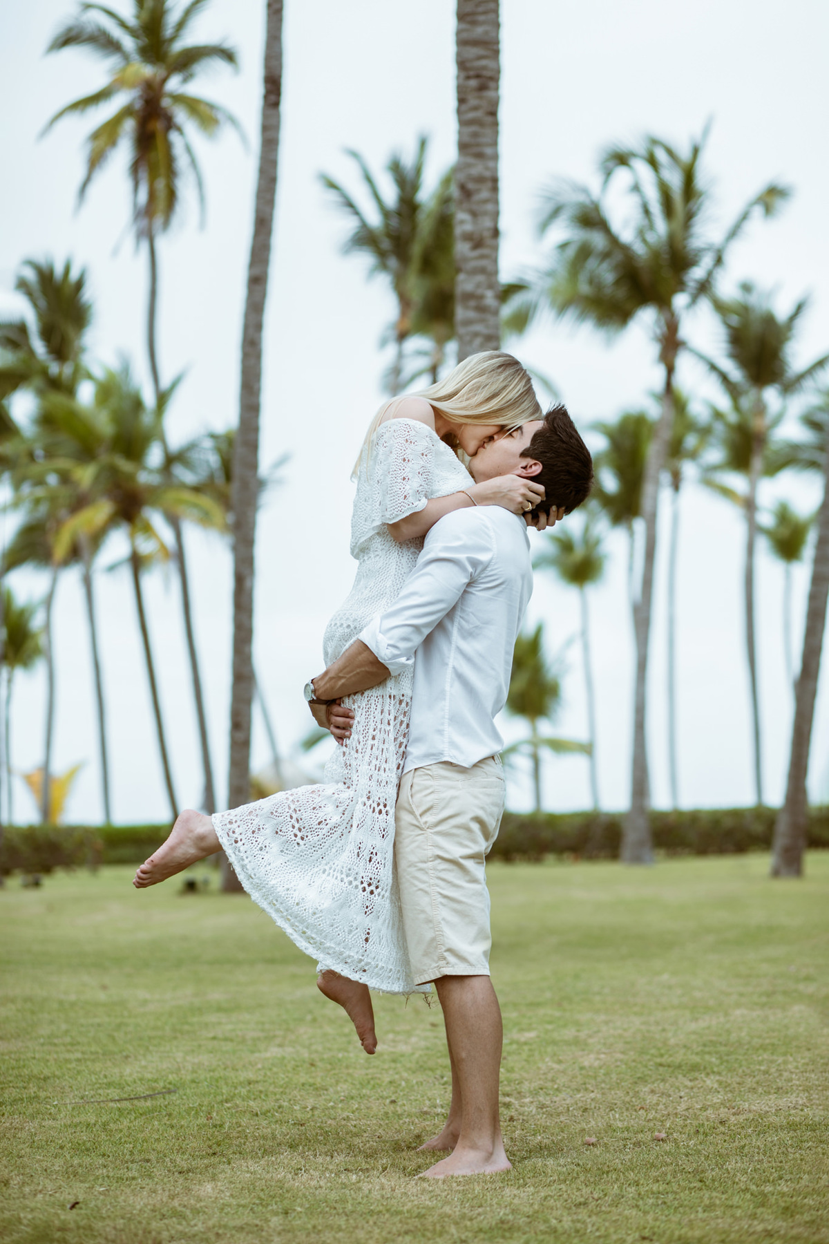 Noiva beijando o noivo. Ensaio de romântico na praia realizado no resort Barceló Bávaro Palace na República Dominicana pelo fotógrafo de casamento Rafael Ohana