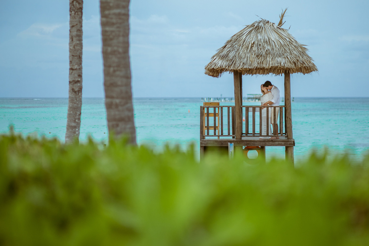 Noivos se abraçando em praia do Caribe. Ensaio de romântico na praia realizado no resort Barceló Bávaro Palace na República Dominicana pelo fotógrafo de casamento Rafael Ohana
