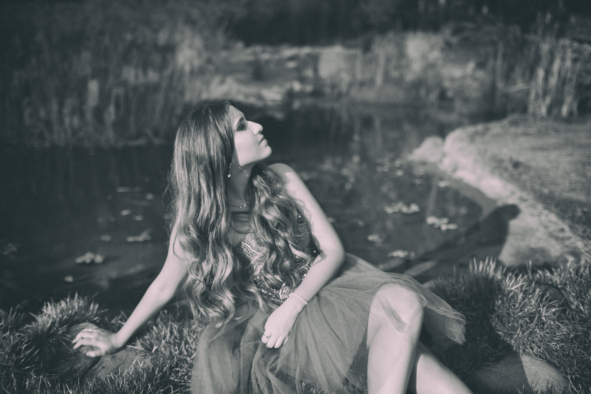 Debutante sentada perto do lago. Ensaio de debutante feito no Jardim Botânico de Brasília pelo fotógrafo Rafael Ohana