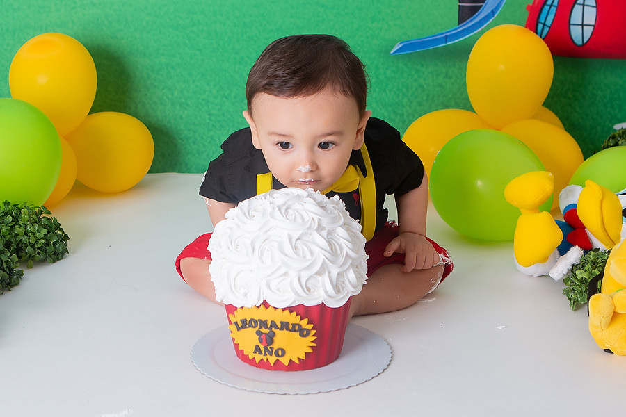 ensaio smash the cake, com tema a casa do mickey mouse, com bolo temático, festa diferente para comemorar 1 ano, festa de 1 ano, esmagando o bolo. 