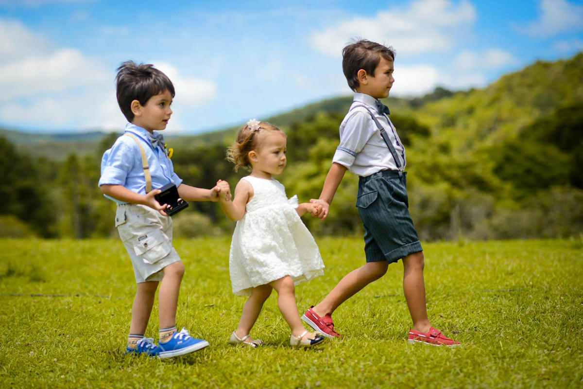 Casamento dos noivos Anna e Bruno ao ar livre em um dia lindo, na região de Curitiba e Campo Largo, fotografado pelo fotógrafo de casamentos Michel Druziki. Daminha e pagens entrando com as alianças