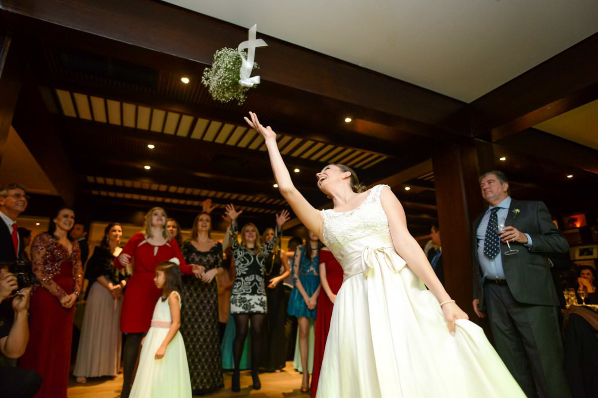 Casamento dos noivos Nayara e Emílio, fotografado pelo fotógrafo de ensaios e casamento em Campo Largo e Curitiba, Michel Druziki. Noiva jogando o buquê