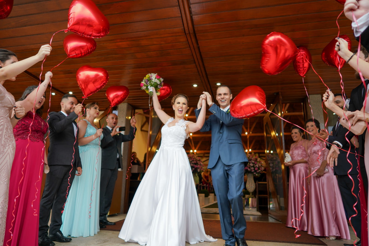 Casamento dos noivos Francine e Rodrigo realizado em Curitiba, com festa no restaurante Madalosso, fotografado pelo melhor fotógrafo de casamentos de Campo Largo e Curitiba, Michel Druziki. Saída dos noivos da igreja com balões de coração