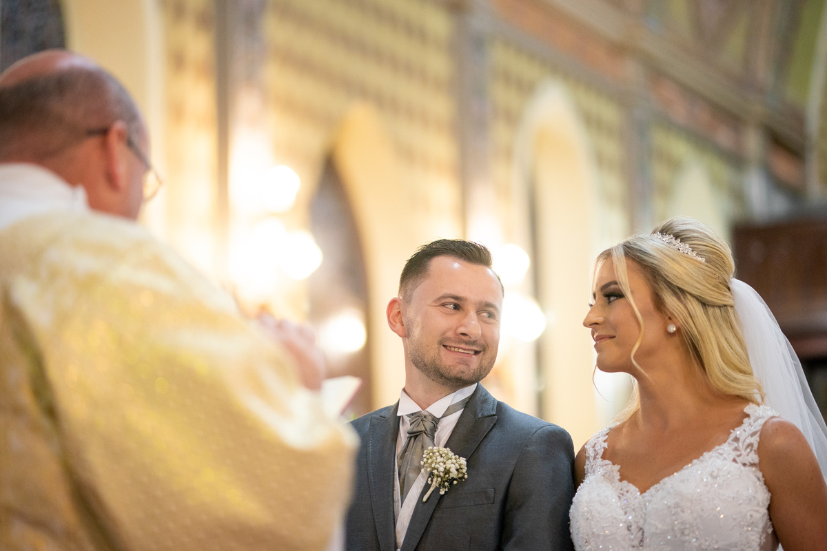 Casamento lindo da Ana Maria e Ricardo, na igreja Matriz, fotografado pelo fotógrafo de casamentos em Campo Largo e Curitiba, Michel Druziki. Noivos se olhando e sorrindo durante a cerimônia