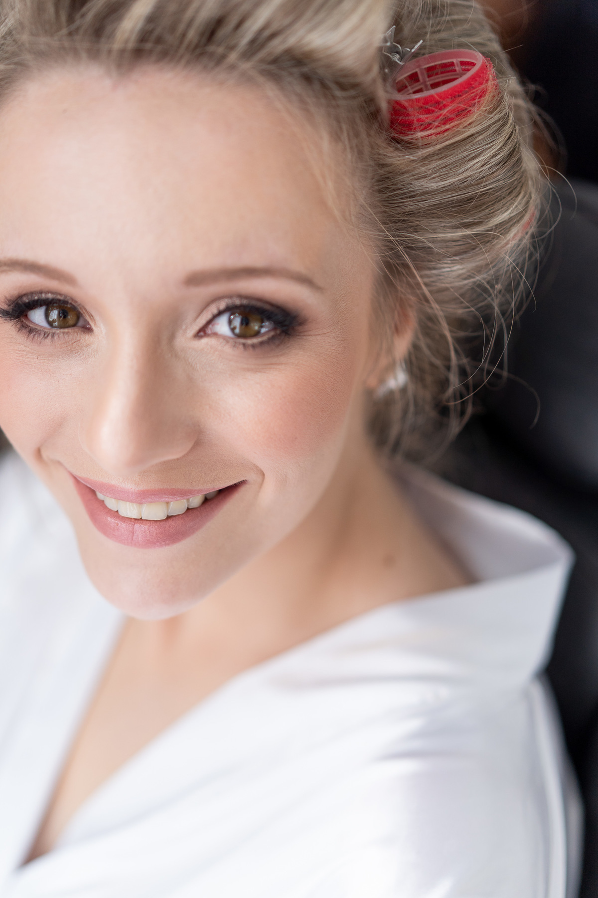 Making of no hotel, feito pelo fotógrafo de casamentos em Campo Largo e Curitiba, Michel Druziki. Casamento Daniela e Paulo, em Curitiba. Noiva se arrumando e sorrindo.