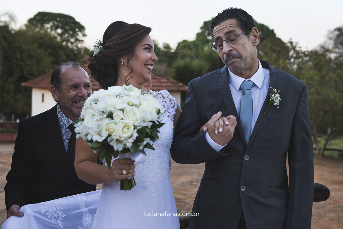  PAI RECEBENDO A NOIVA NA ENTRADA DO CASAMENTO  FOTOGRAFIA EMOCIONANTE DA NOIVA COM O PAI FEITAS PELA FOTÓGRAFA DE CASAMENTO LUCIANA FARIA DE POÇOS DE CALDAS-