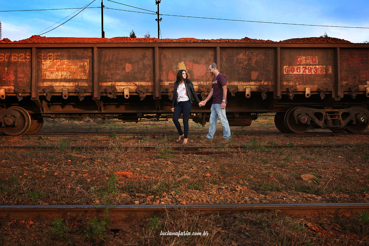 caminhando pela linha do trem entre os vagões o casal faz fotografias  que ganharam de presente de dia dos namorados o ensaio foi realizado com luciana faria que é fotógrafa em poços de caldas onde as fotografias foram tiradas