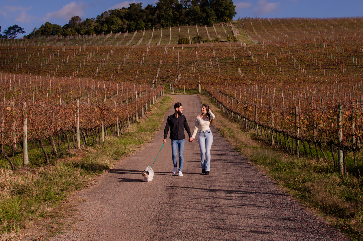 casal em ensaio fotografico com a fotografa jociane cagol caminhando com seu cachorro 