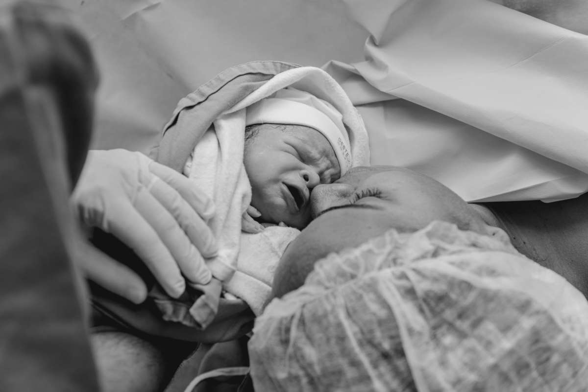 Mãe beijando o bebê após o nascimento na Oeste Dor, Campo Grande, Rio de Janeiro, por Andréa Costa