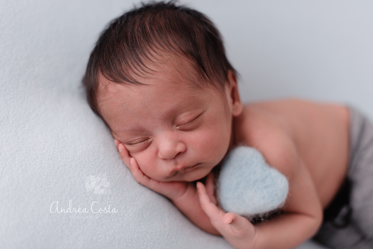 recém nascido segurando um coração azul em pose linda para ensaio newborn Rio de Janeiro, por Andréa Costa