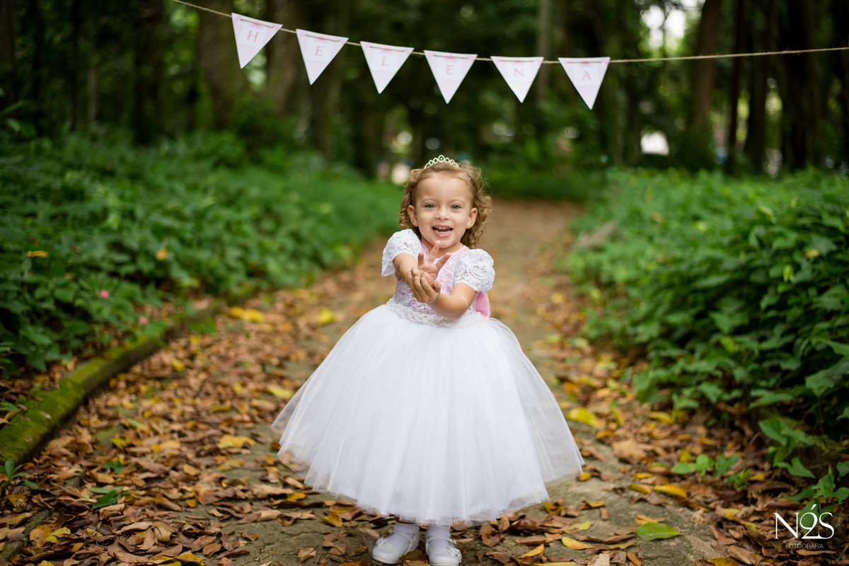 ensaio de três anos da helena no parque lage sorrindo com vestido de princesa