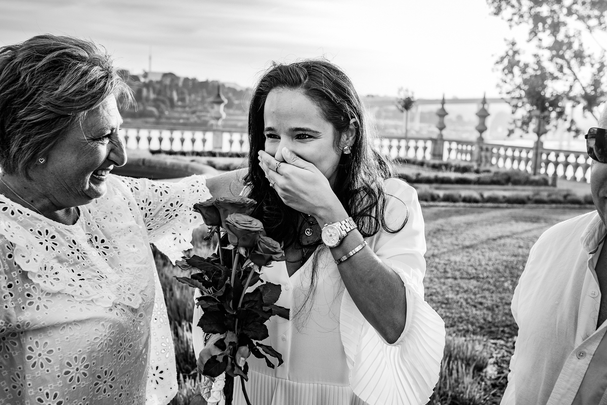 Noiva a sorrir, emocionada, enquanto chora de alegria.