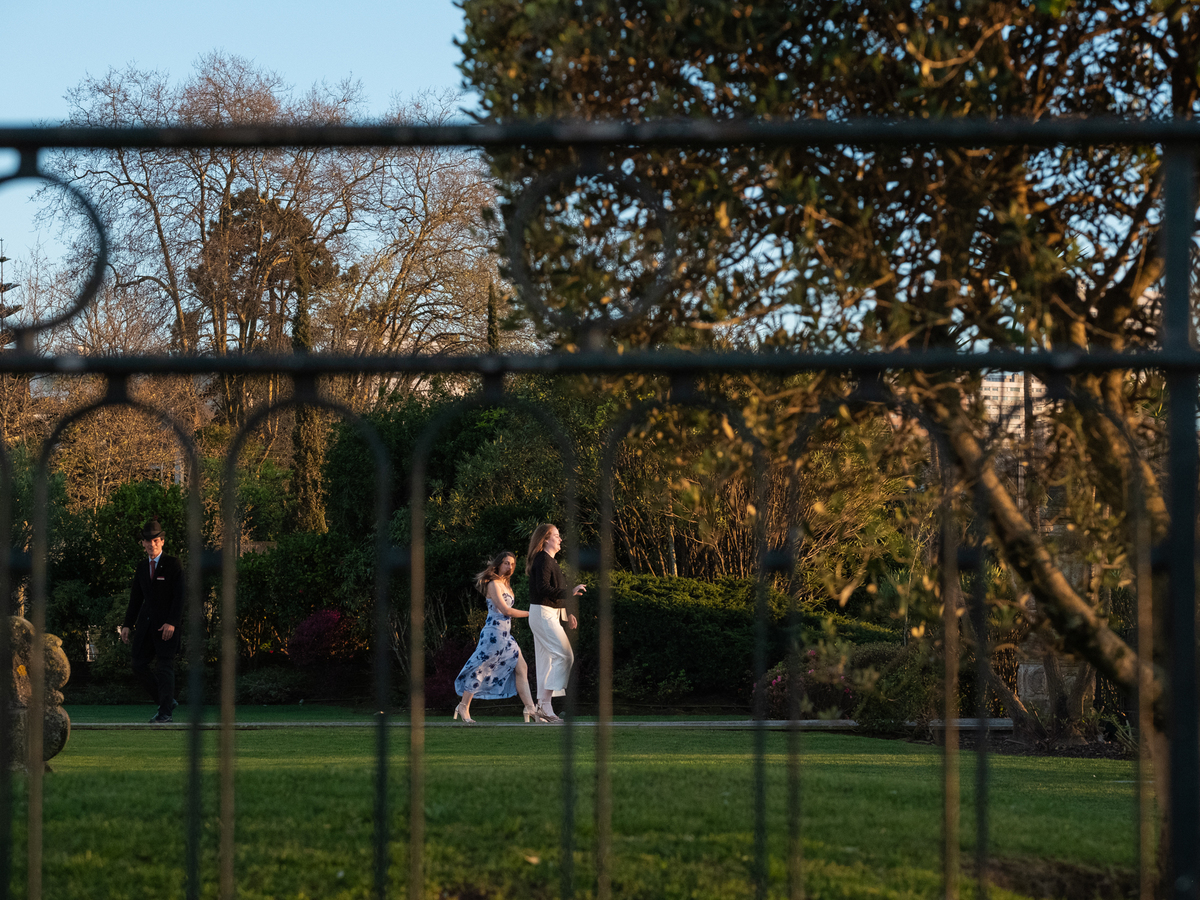 Claire and Julia walking hand in hand through the Yeatman garden