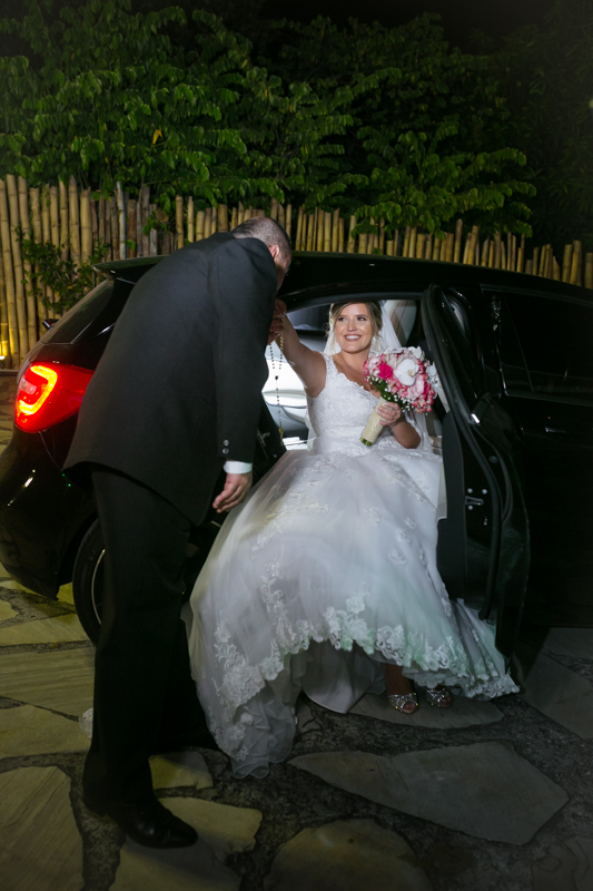 Noiva saindo do carro pai beijando sua mão Coliseum Eventos