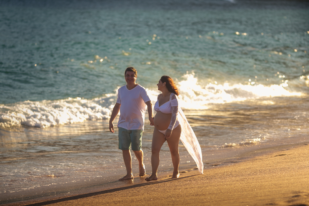 Casal caminhando  na praia em ensaio gestante Grumari/RJ 