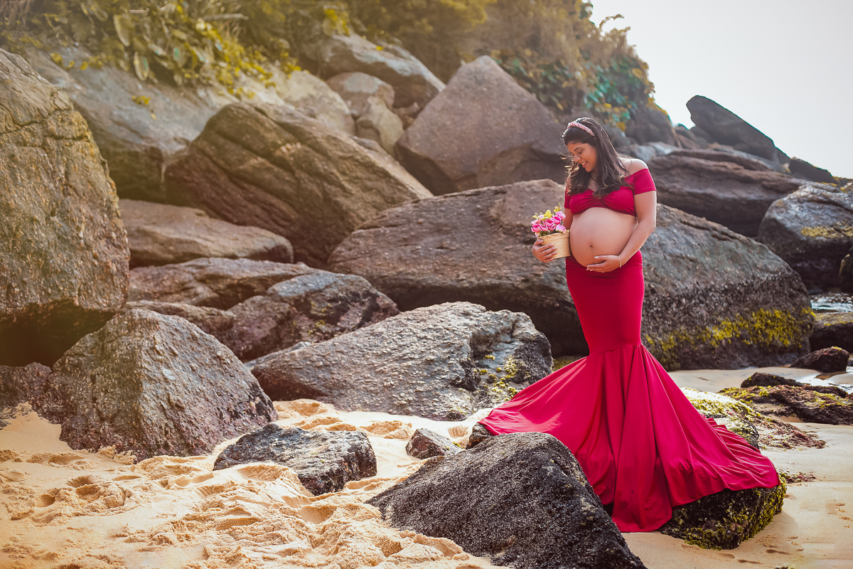 gestante fazendo poses em cima da pedra em pra da urca em seu ensaio fotografico -rj