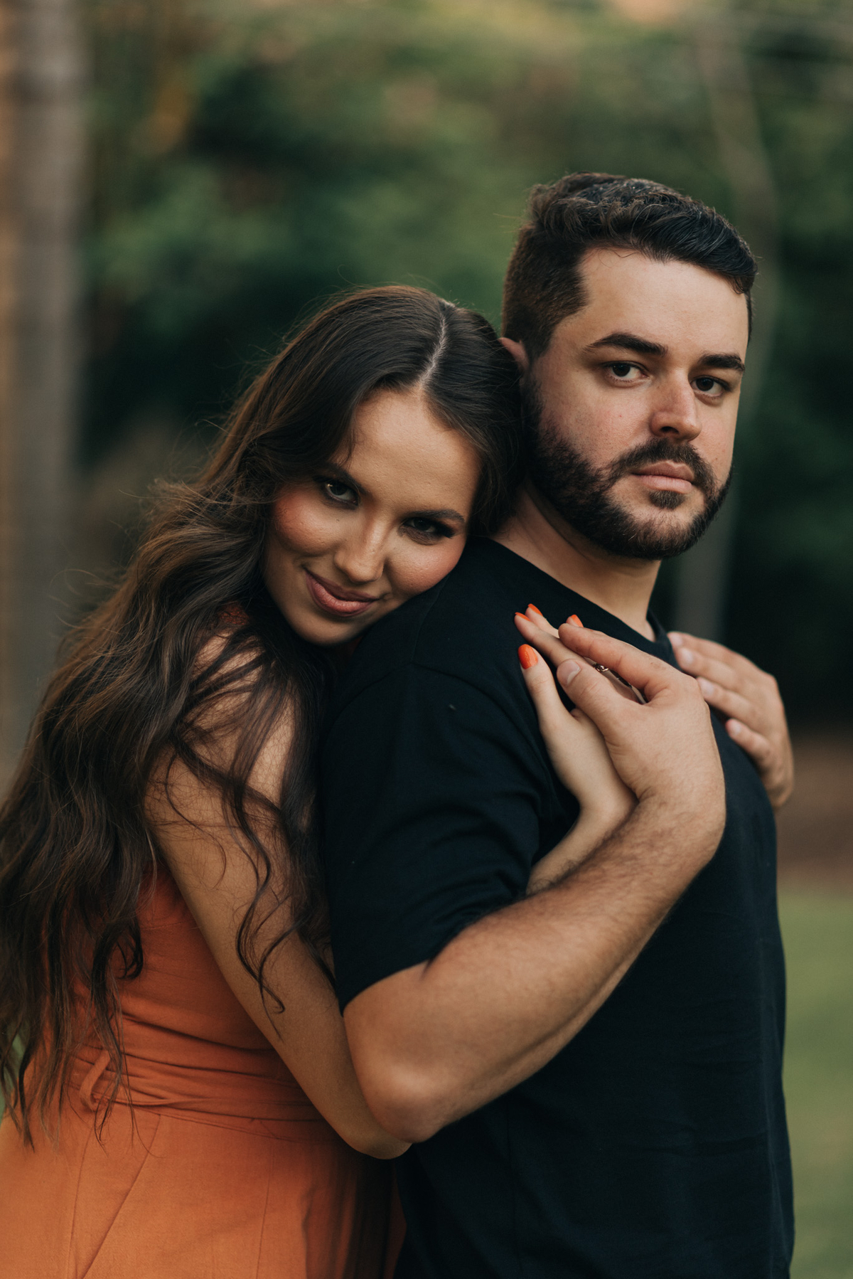 noiva abraçando o noivo pelas costas 