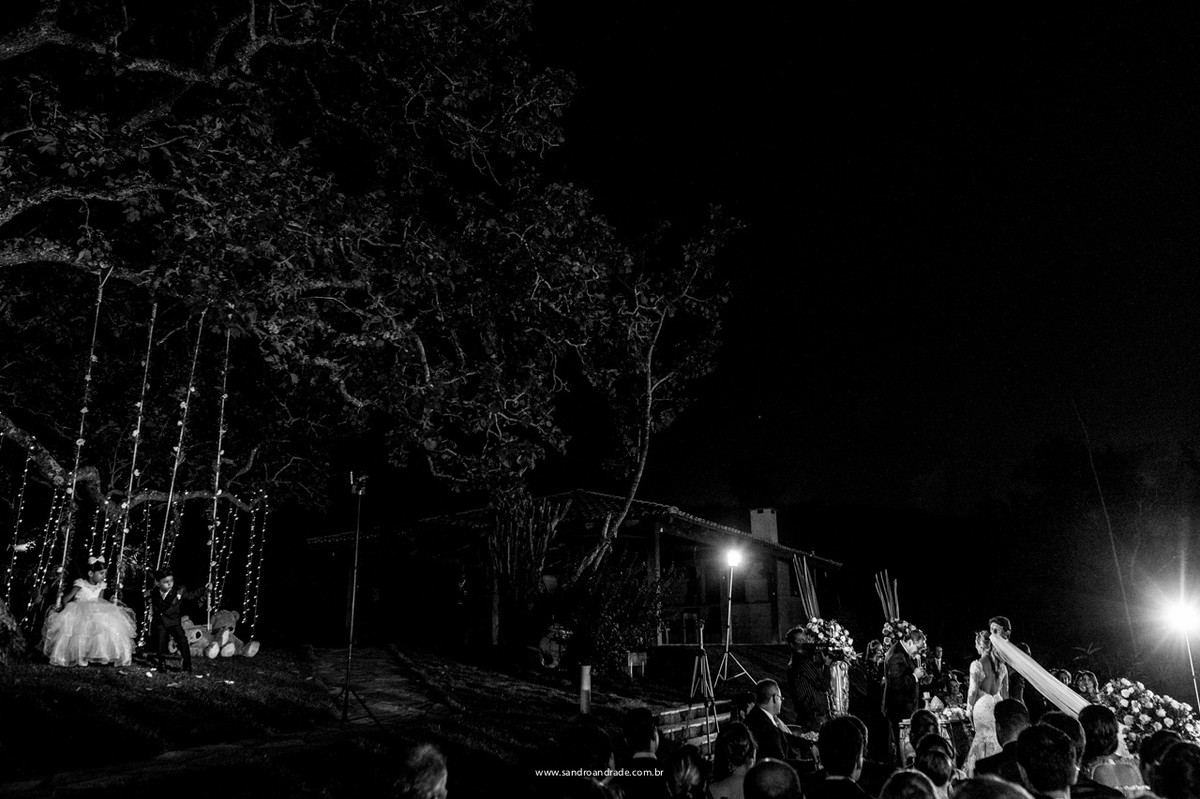 Linda cerimonia de casamento, enquanto isso as crianças se divertem nos balanços.