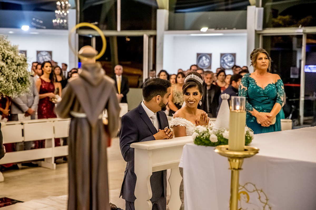 Após a oração, ainda ajoelhados, eles se olham e sorriem.