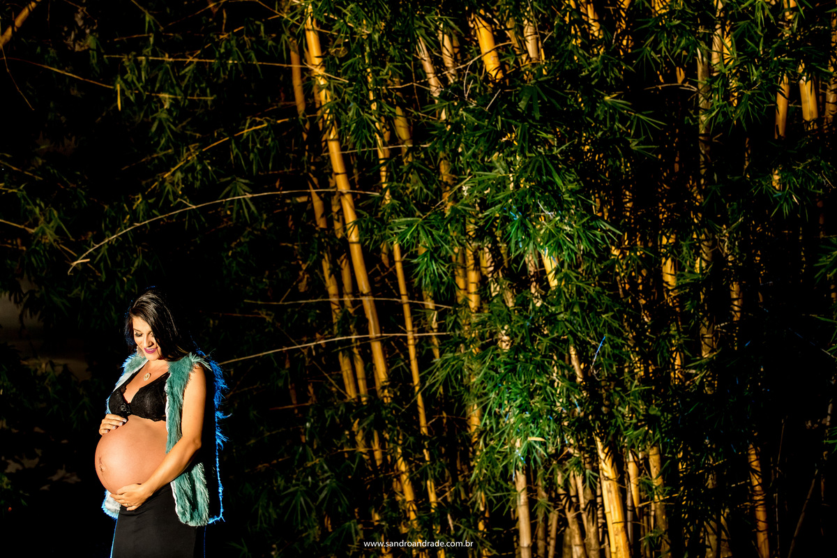 Ainda próxima dos bambus ela olha para sua barriga linda e sorri.