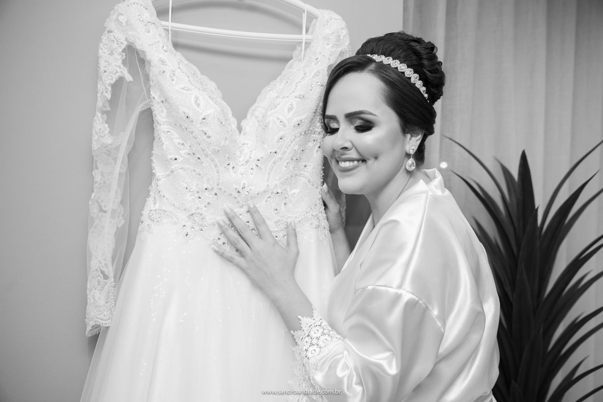 Feliz ela chega bem pertinho do seu vestido, fecha os olhos, sorri e pensa no momento que se aproxima.