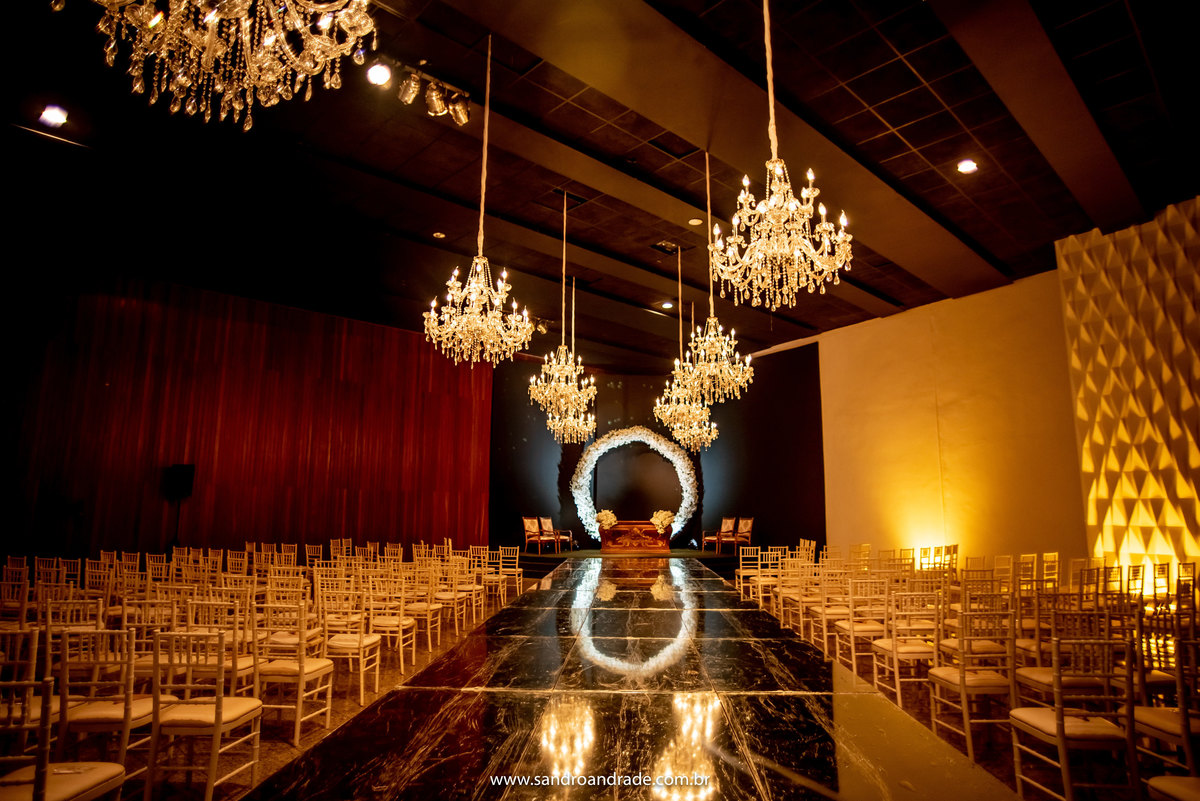 A área da cerimonia estava muito lindaaaa, com tapete espelhado, um arco de flores brancas no altar e lindos lustres.