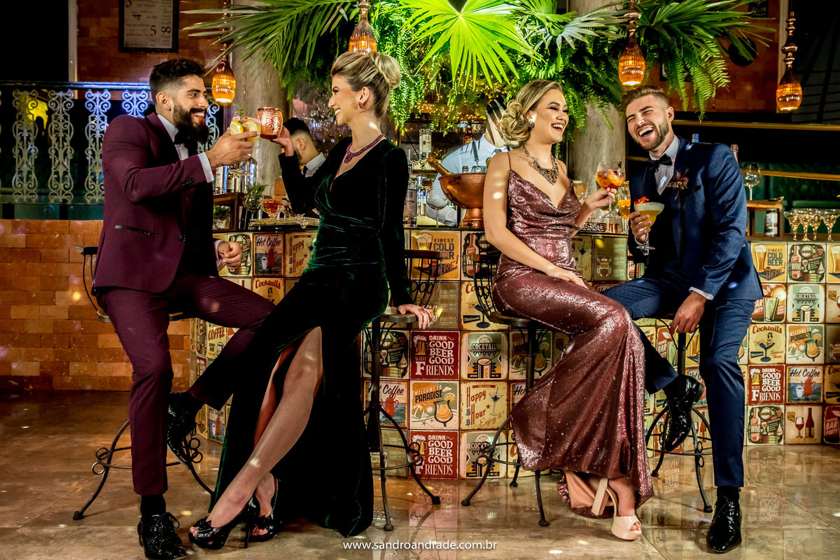Os casais estão brindando no bar da boate.